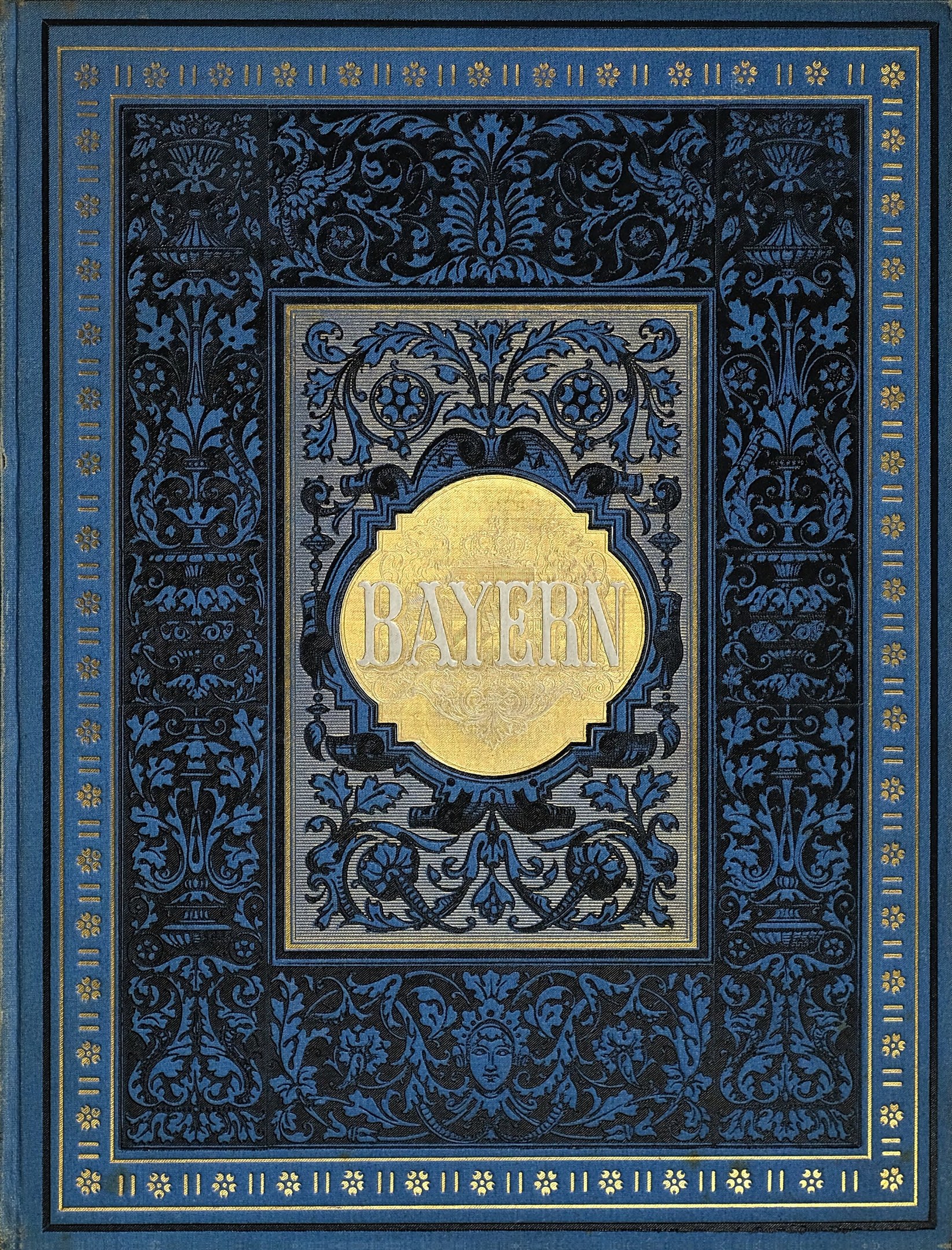 Blau-goldenes Buch mit dem Wort 'Bayern' auf dem Cover, verziert mit aufwändigen Dekorationen.