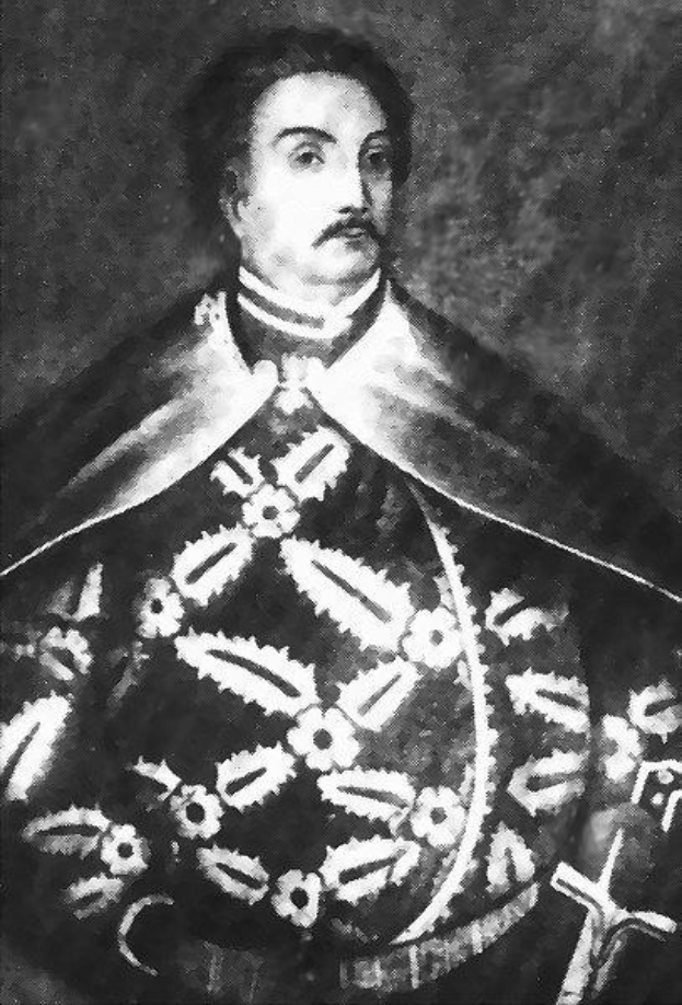 Schwarzes und weißes Foto von Papst Johannes Paul II. in Priesterroben, der eine schwarze Robe mit weißem Kragen und Manschetten trägt und die Hände verschränkt, mit einem strengen Gesichtsausdruck und direktem Blick.