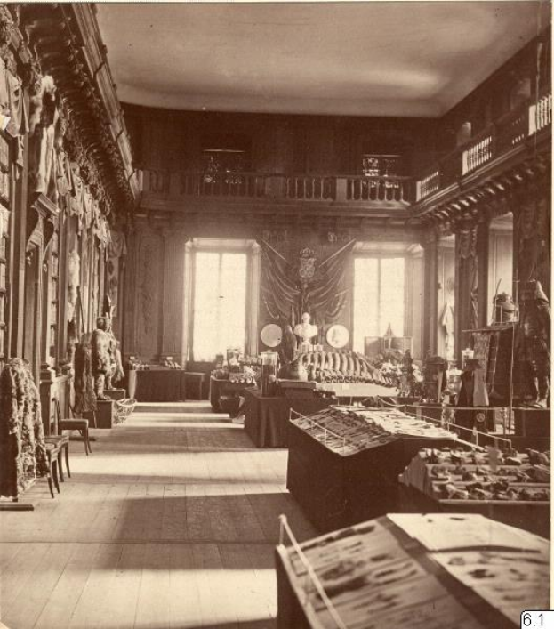 Schwarzes und weißes Foto eines Raums im Museum of Fine Arts, London, mit Tischen, Stühlen, an der Wand befestigten Skulpturen, Fenstern mit Vorhängen und Geländern.